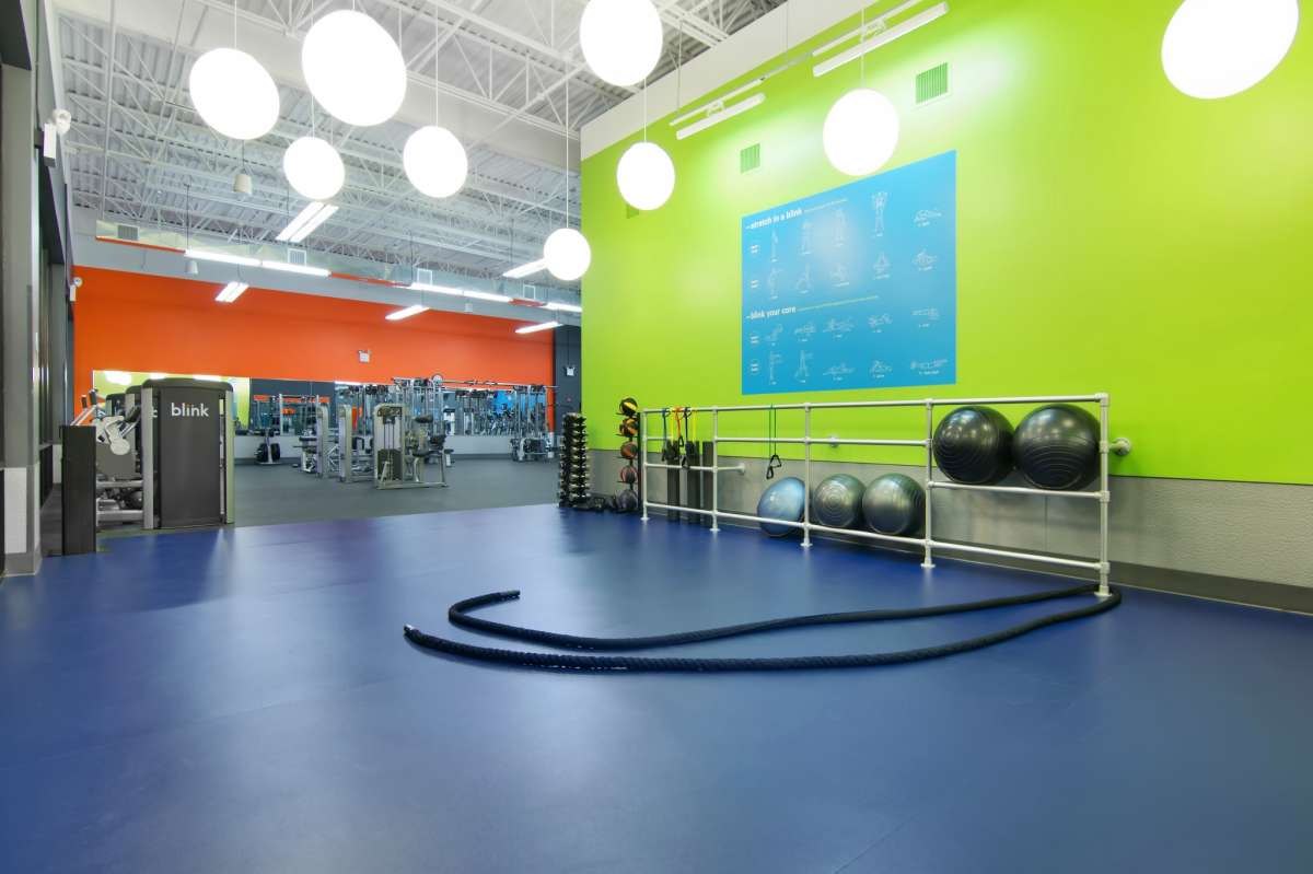 Blue training floor with a stretch-in-a-blink wall graphic