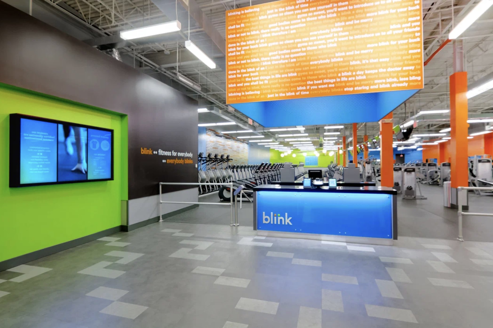 Branded reception desk against a green and blue color wall