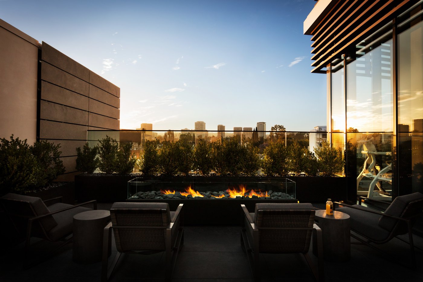 Equinox Century City rooftop terrace with fire pits at dusk