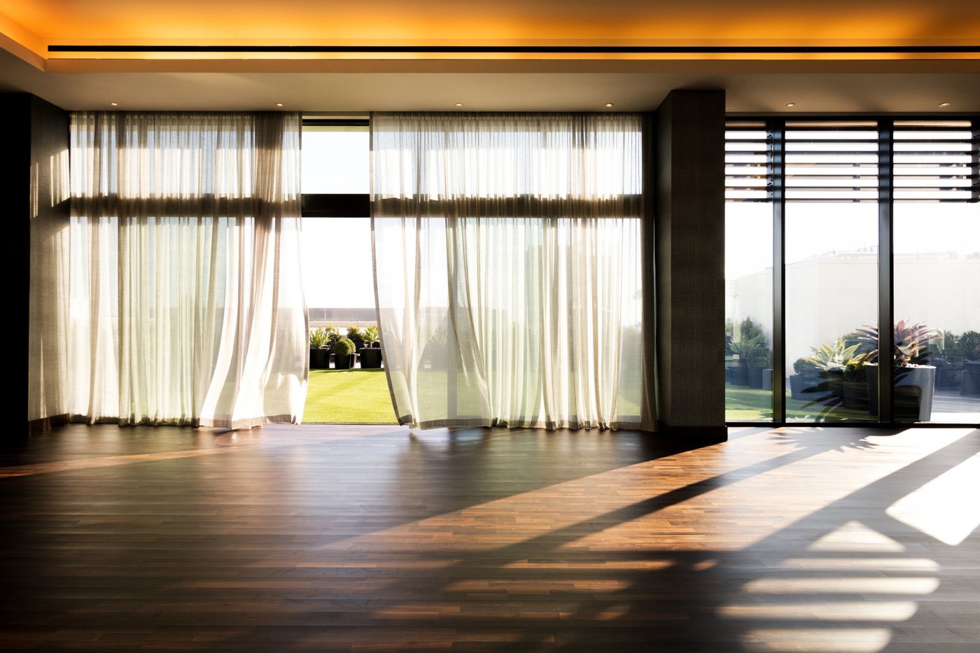 Equinox Century City studio with sheer curtains and city light