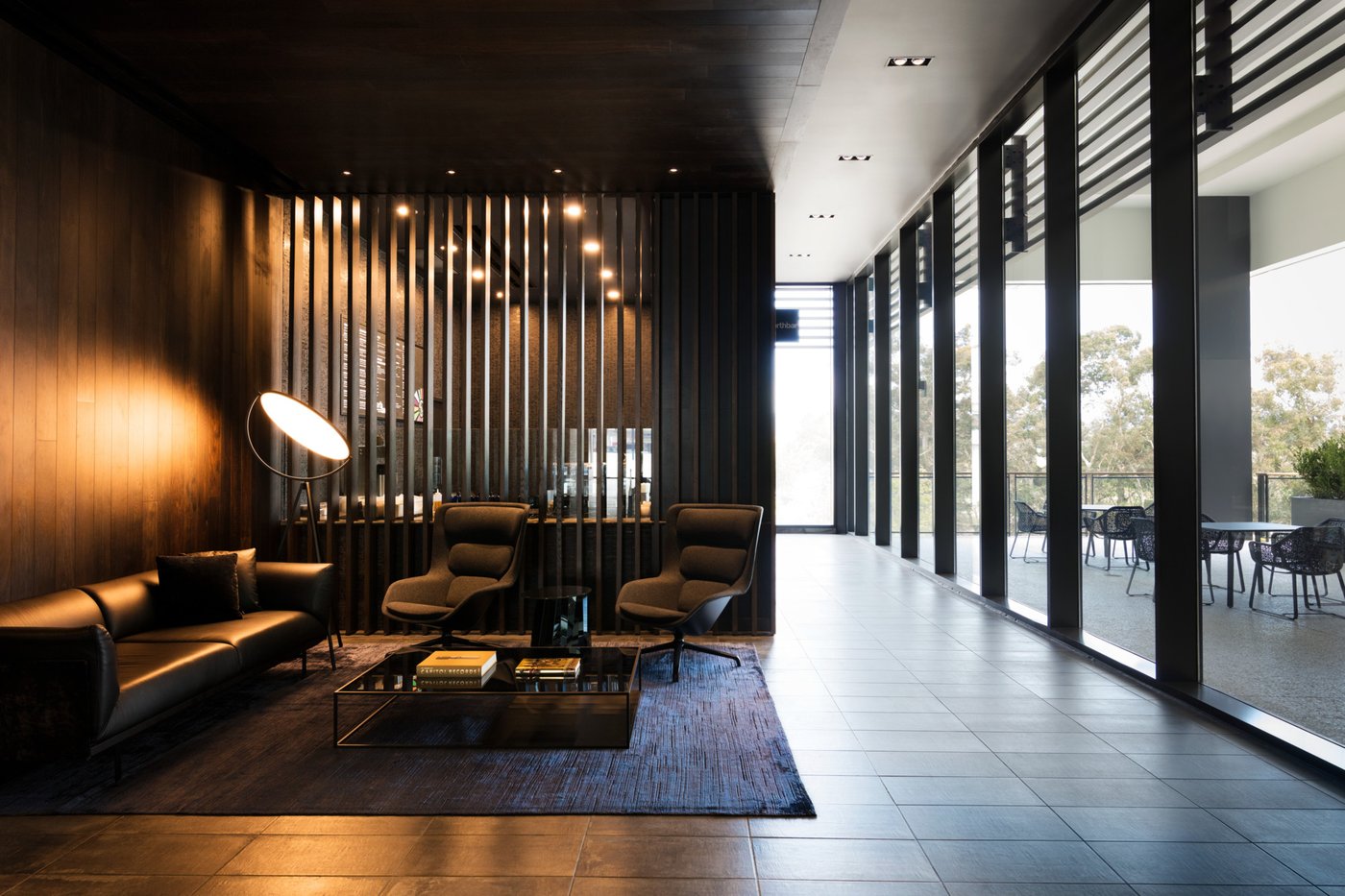 Equinox Century City lounge with a floor lamp and city view