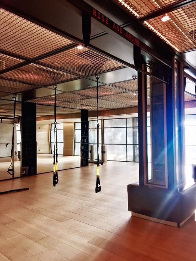Studio bay with suspension trainers and tall factory windows