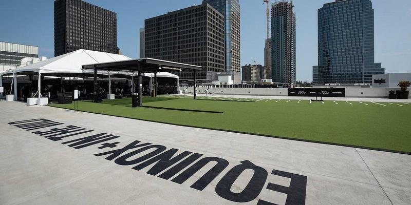 Rooftop turf field with the painted In the Wild wordmark, Century City, Los Angeles