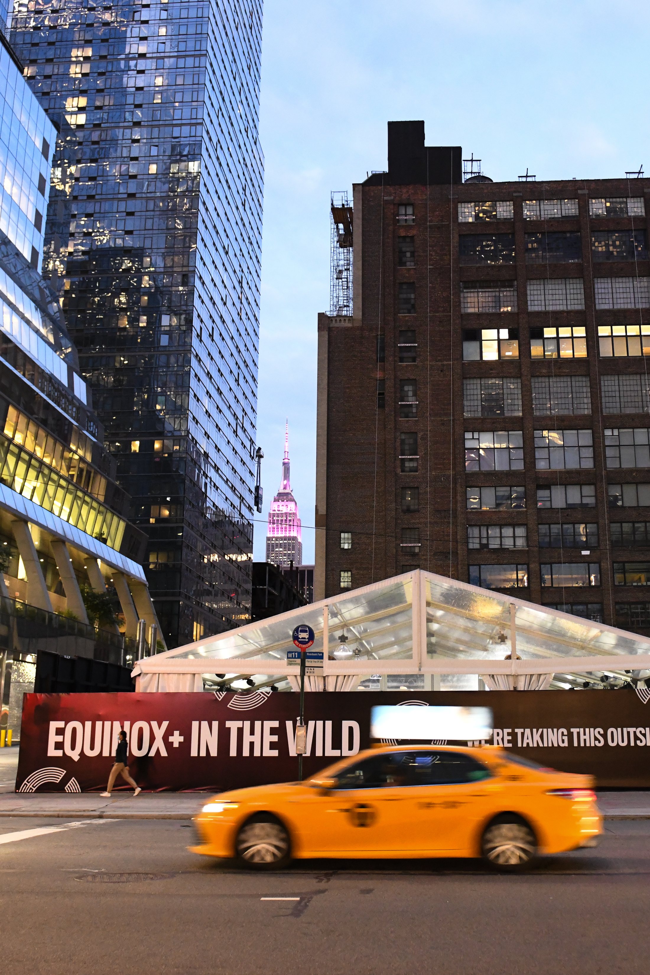 Street tent at dusk with the New York skyline beyond