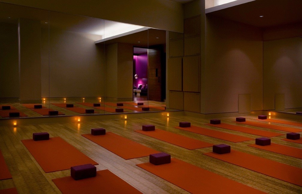 Practice room with orange mats and a mirrored wall